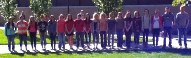 Group of students standing in line in order based on their height