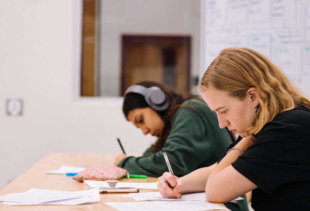 Students making exam using pen and paper